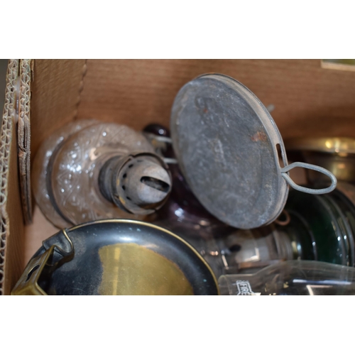 460 - A mixed collection of vintage and antique tin, pottery and brass oil lamps with glass chimneys and p... 