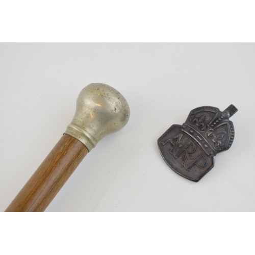 440A - A swagger stick together with a wartime period silver ARP 'Air Raid Precautions' badge. (2)