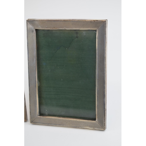 548 - A trio of Art Deco graduated 800 silver engine turned photo frames c1930s. 15.5cm x 11.5cm, 17cm x 1... 