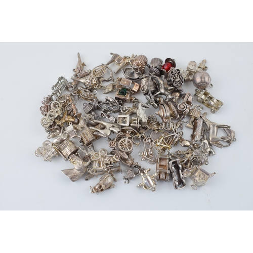 552 - A large collection of silver / silver coloured metal charms to include sporting items, birds, animal... 