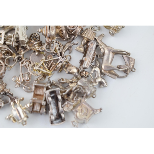 552 - A large collection of silver / silver coloured metal charms to include sporting items, birds, animal... 