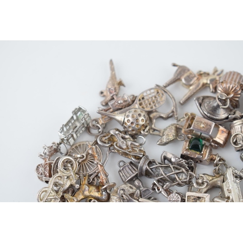 552 - A large collection of silver / silver coloured metal charms to include sporting items, birds, animal... 