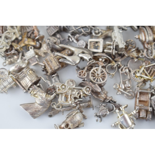 552 - A large collection of silver / silver coloured metal charms to include sporting items, birds, animal... 