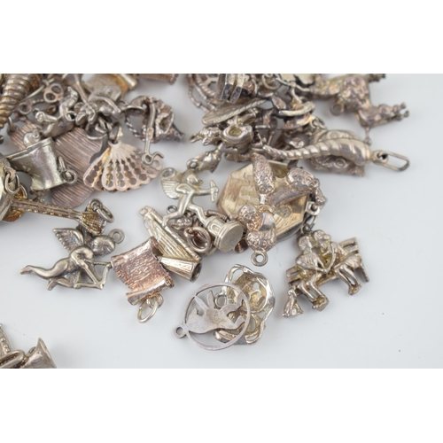 553 - A large collection of silver / silver coloured metal charms to include musical instruments, love hea... 