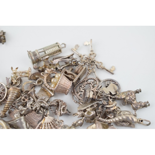 553 - A large collection of silver / silver coloured metal charms to include musical instruments, love hea... 