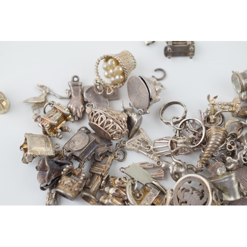 553 - A large collection of silver / silver coloured metal charms to include musical instruments, love hea... 