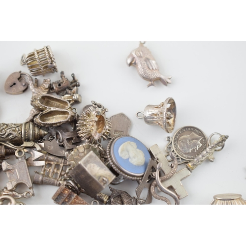 557 - A large collection of silver charms to include animals, tankards and others, 168g.