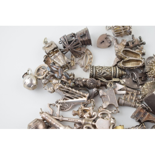 557 - A large collection of silver charms to include animals, tankards and others, 168g.