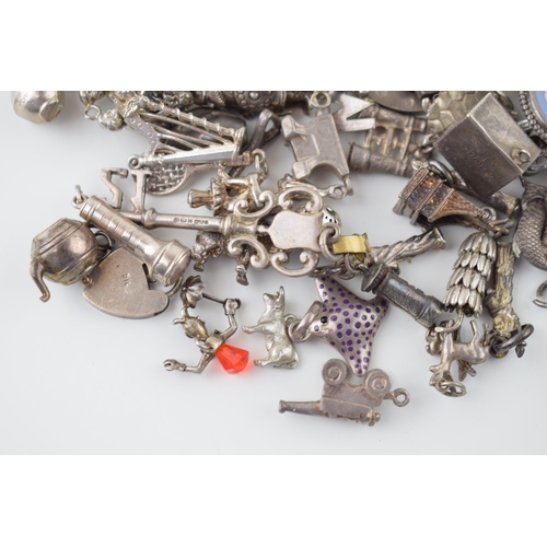 557 - A large collection of silver charms to include animals, tankards and others, 168g.