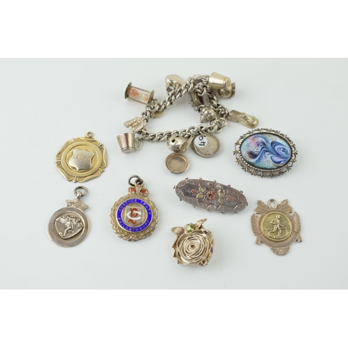 558 - Silver to include a charm bracelet, with four silver fobs and three brooches, 117.8g.