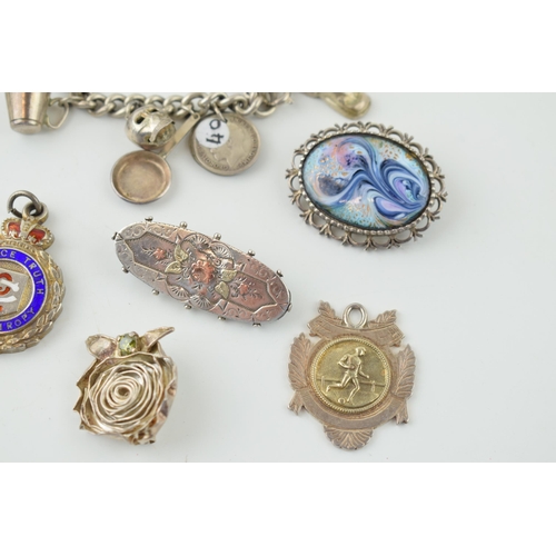 558 - Silver to include a charm bracelet, with four silver fobs and three brooches, 117.8g.