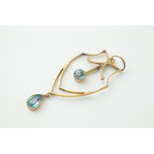 563 - A 9cy yellow gold Art Nouveau drop pendant set with two aquamarine stone. Weight 1.3 grams.