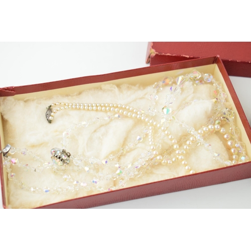 566 - A collection of vintage jewellery items to include a set of pearls a boxed Swarovski jewellery simiu... 