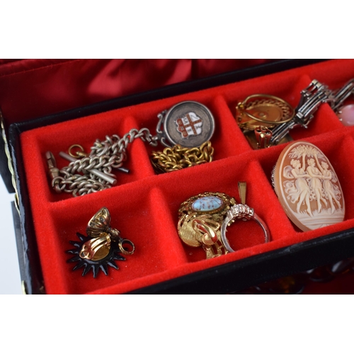 568 - A jewellery box of costume jewellery to include a metal albert watch chain with a silver fob, a Jady... 