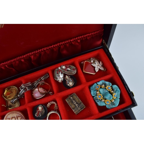 568 - A jewellery box of costume jewellery to include a metal albert watch chain with a silver fob, a Jady... 