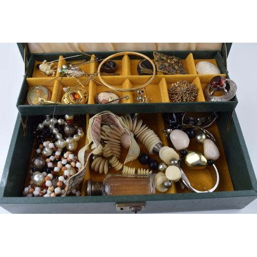 569 - A jewellery box with costume jewellery to include a silver topped glass jar, hat pins, a bronzed sma... 