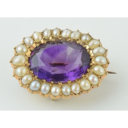 624 - 9ct gold brooch, central amethyst surrounded by pearls, tests as 9ct gold, 4.7g.