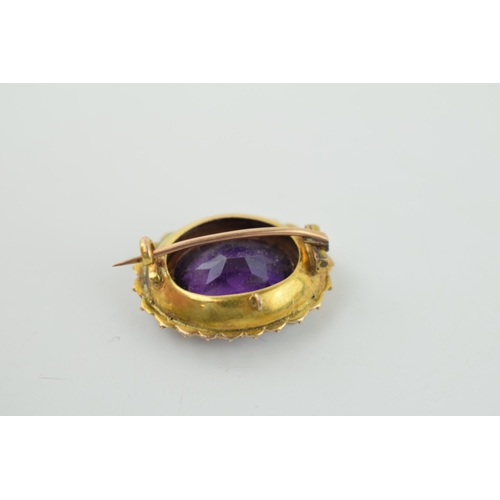 624 - 9ct gold brooch, central amethyst surrounded by pearls, tests as 9ct gold, 4.7g.