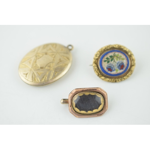 626 - Three gold cased items of jewellery to include a locket, a mourning brooch and a mosaic (3).