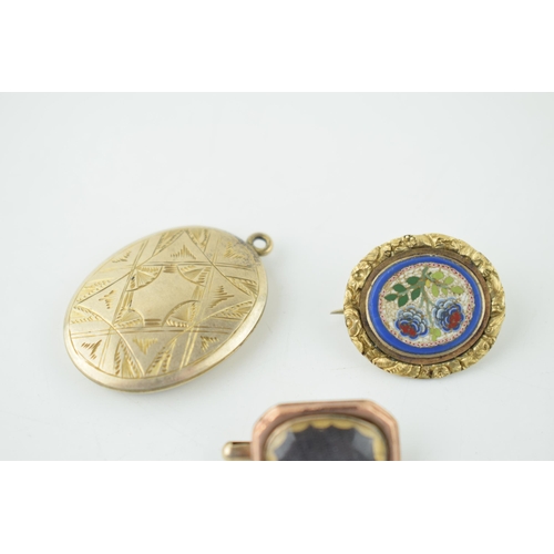 626 - Three gold cased items of jewellery to include a locket, a mourning brooch and a mosaic (3).