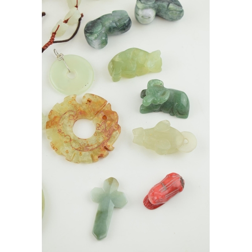 375 - A collection of Jadeite, Jade and similar hard stone carved items to include Bi discs, animals and j... 