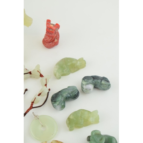 375 - A collection of Jadeite, Jade and similar hard stone carved items to include Bi discs, animals and j... 