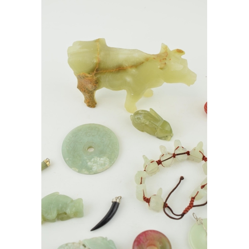 375 - A collection of Jadeite, Jade and similar hard stone carved items to include Bi discs, animals and j... 