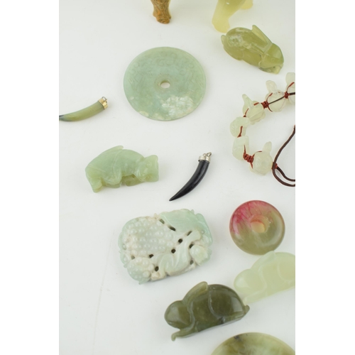 375 - A collection of Jadeite, Jade and similar hard stone carved items to include Bi discs, animals and j... 