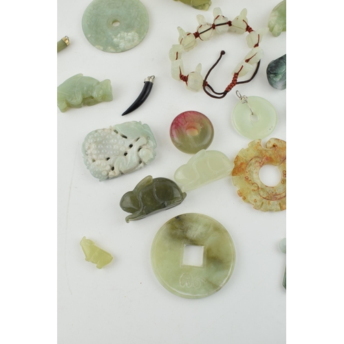 375 - A collection of Jadeite, Jade and similar hard stone carved items to include Bi discs, animals and j... 