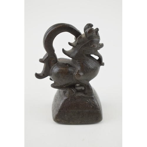 377 - An opium weight, in the form of a dragon, believed Burmese bronze, 7cm tall.