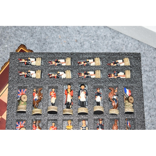 379 - A Modern Ornate Chess Set and Board the chess pieces depicting Napoleonic soldiers in original box