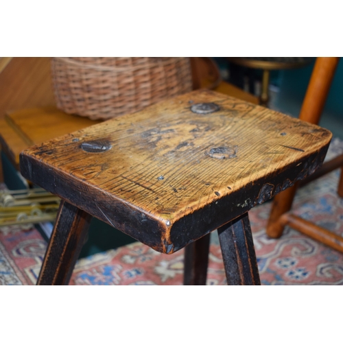 384 - Late 18th / early 19th century three legged country stool, made from elm / ash, showing signs of cha... 