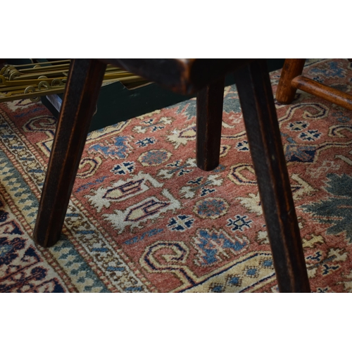 384 - Late 18th / early 19th century three legged country stool, made from elm / ash, showing signs of cha... 