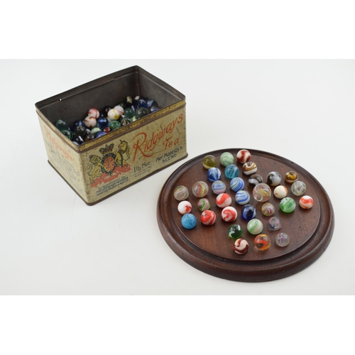 394 - A collection of antique and later marbles, swirling decoration, with vintage wooden games board (Qty... 