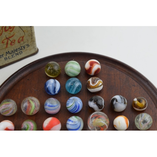 394 - A collection of antique and later marbles, swirling decoration, with vintage wooden games board (Qty... 