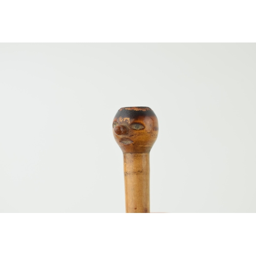 397 - Treen novelty cheroot holder, with carved face, in wooden sleeve, 9cm long.