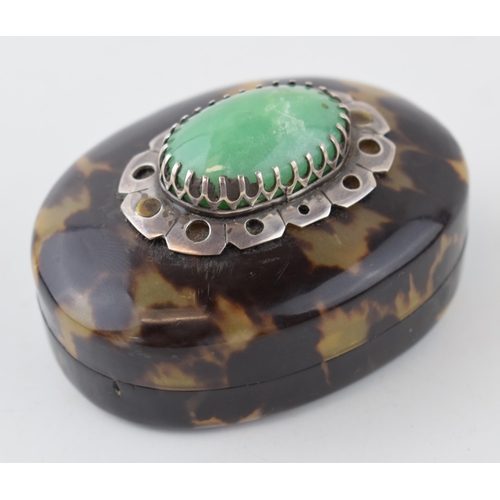 398 - Tortoiseshell lidded comport with jade style stone set in white metal mount, 7cm long.