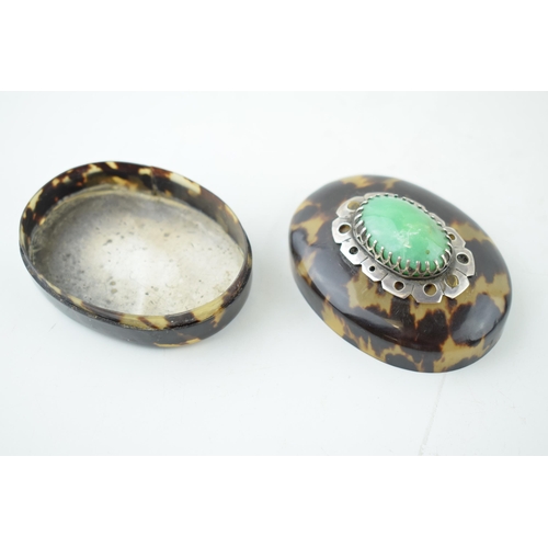 398 - Tortoiseshell lidded comport with jade style stone set in white metal mount, 7cm long.