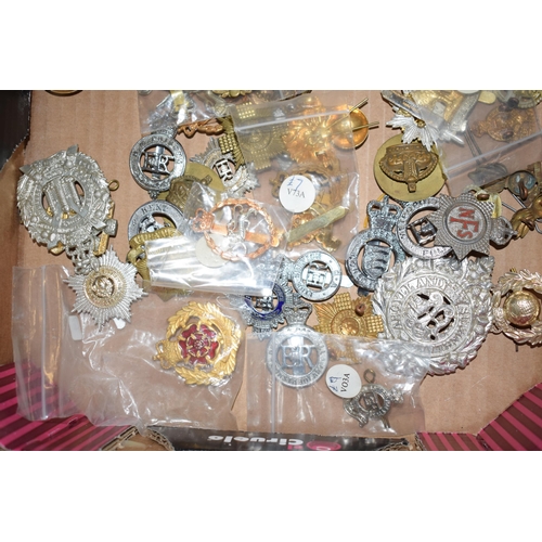 435 - A large collection of military cap badges, mostly WWI and WWII era mainly British and German. (Qty)