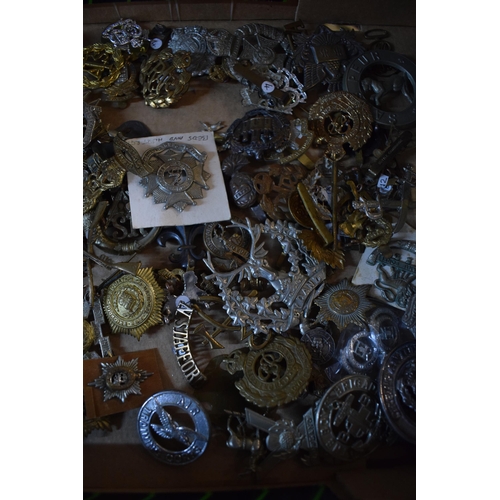 438 - A large collection of military cap badges, WWI and WWII era mainly British Army. (Qty)