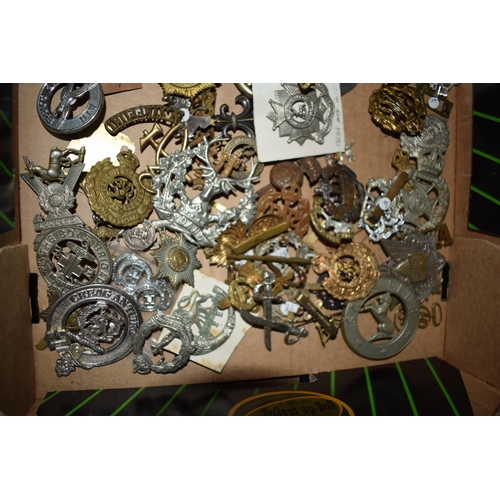 438 - A large collection of military cap badges, WWI and WWII era mainly British Army. (Qty)