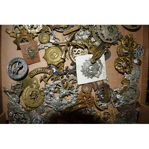 438 - A large collection of military cap badges, WWI and WWII era mainly British Army. (Qty)