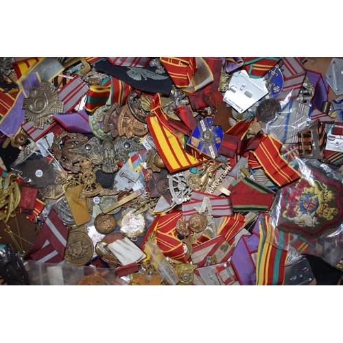 439 - A large collection of medal ribbons, cloth badges and cap badges, WWI and WWII era mainly British Ar... 