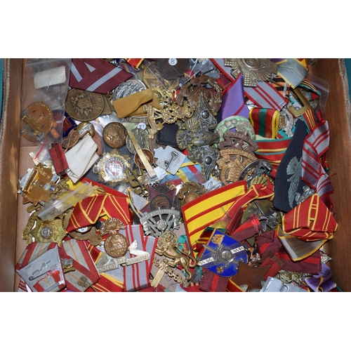 439 - A large collection of medal ribbons, cloth badges and cap badges, WWI and WWII era mainly British Ar... 