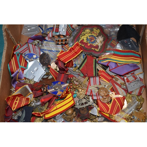 439 - A large collection of medal ribbons, cloth badges and cap badges, WWI and WWII era mainly British Ar... 