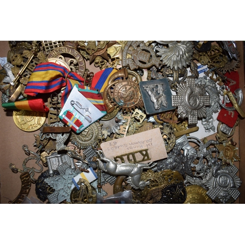 440 - A large collection of military cap badges, ribbons and similar items, WWI and WWII era mainly Britis... 