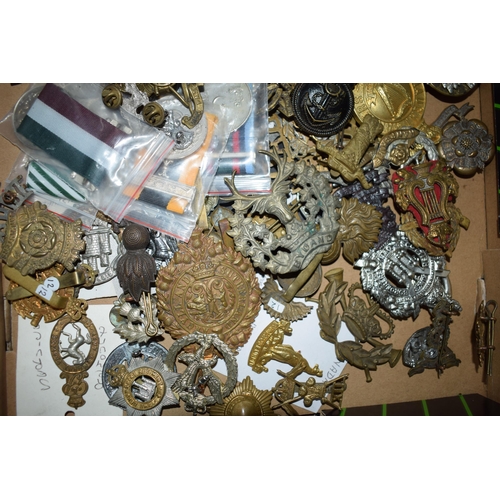 440 - A large collection of military cap badges, ribbons and similar items, WWI and WWII era mainly Britis... 