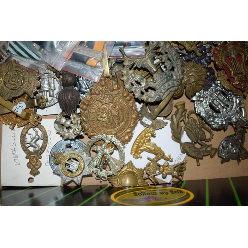 440 - A large collection of military cap badges, ribbons and similar items, WWI and WWII era mainly Britis... 