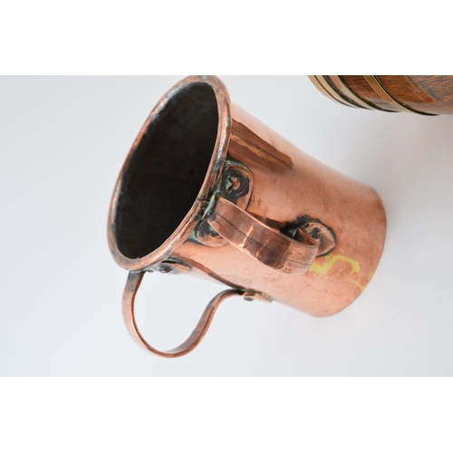 457 - A Victorian two handled copper drinking or cooking vessel, riveted handles, with an oak and brass co... 