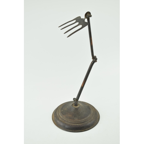 461 - Vintage copper and cast iron articulated toaster or toasting fork on a stand